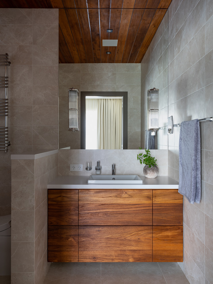 Immagine di una stanza da bagno contemporanea con lavabo da incasso e pavimento grigio