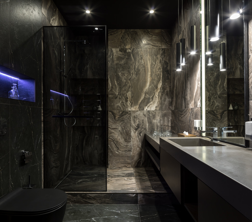 Inspiration för ett mellanstort funkis grå grått badrum med dusch, med släta luckor, svarta skåp, en kantlös dusch, en vägghängd toalettstol, flerfärgad kakel, marmorkakel, flerfärgade väggar, marmorgolv, ett integrerad handfat, bänkskiva i akrylsten, flerfärgat golv och med dusch som är öppen