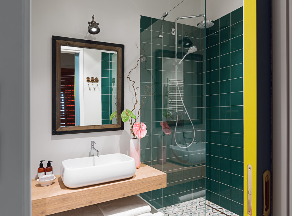 Contemporary shower room bathroom in Other with a corner shower, green tiles, white walls, a vessel sink, wooden worktops, open cabinets, an open shower and brown worktops.