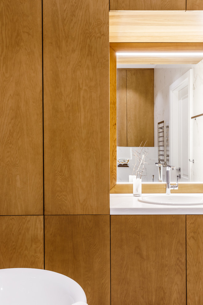 Design ideas for a large contemporary family bathroom in Moscow with flat-panel cabinets, brown cabinets, a bidet, beige tiles, ceramic tiles, beige walls, ceramic flooring, a submerged sink, solid surface worktops, white floors, white worktops and a freestanding bath.
