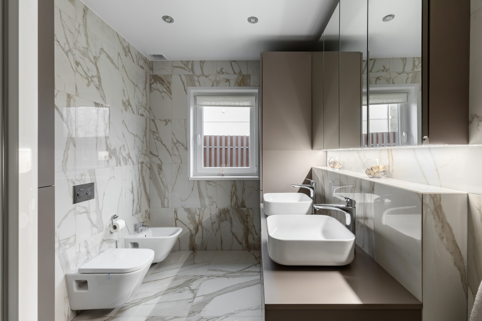 Inspiration för moderna beige badrum, med beige skåp, en bidé, beige kakel, ett fristående handfat och beiget golv