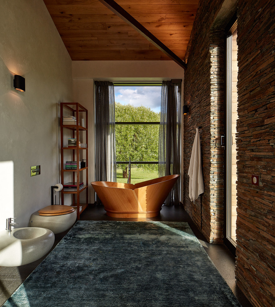 Mittelgroßes Modernes Badezimmer En Suite mit Wandtoilette, Aufsatzwaschbecken, freistehender Badewanne und Steinwänden in Jekaterinburg