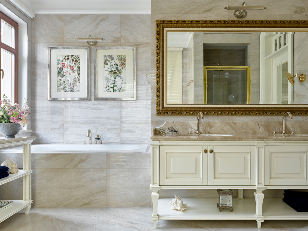 This is an example of a classic grey and cream ensuite bathroom in Moscow with beige cabinets, a built-in bath, beige tiles, a submerged sink, beige floors, beige worktops and raised-panel cabinets.