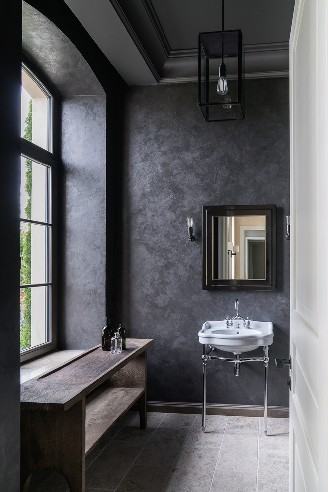 На фото: ванная комната в современном стиле с черными стенами и консольной раковиной