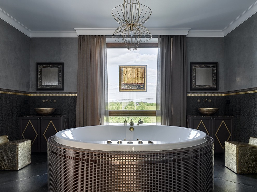 На фото: ванная комната в современном стиле с гидромассажной ванной, черной плиткой, серыми стенами и настольной раковиной