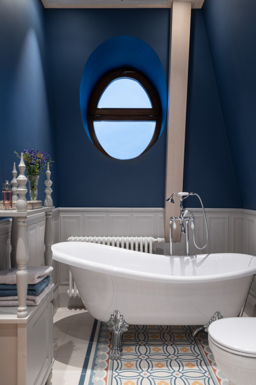 Clawfoot Elegance: Blue Bathroom Ideas with a Clawfoot Bathtub and White Wainscoting