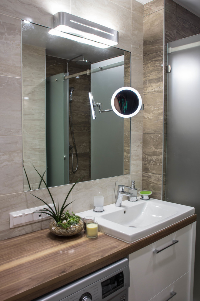 Photo of a medium sized contemporary shower room bathroom in Other with flat-panel cabinets, beige cabinets, an alcove shower, a bidet, brown tiles, ceramic tiles, brown walls, porcelain flooring, a submerged sink, wooden worktops, brown floors, a sliding door, brown worktops and a feature wall.