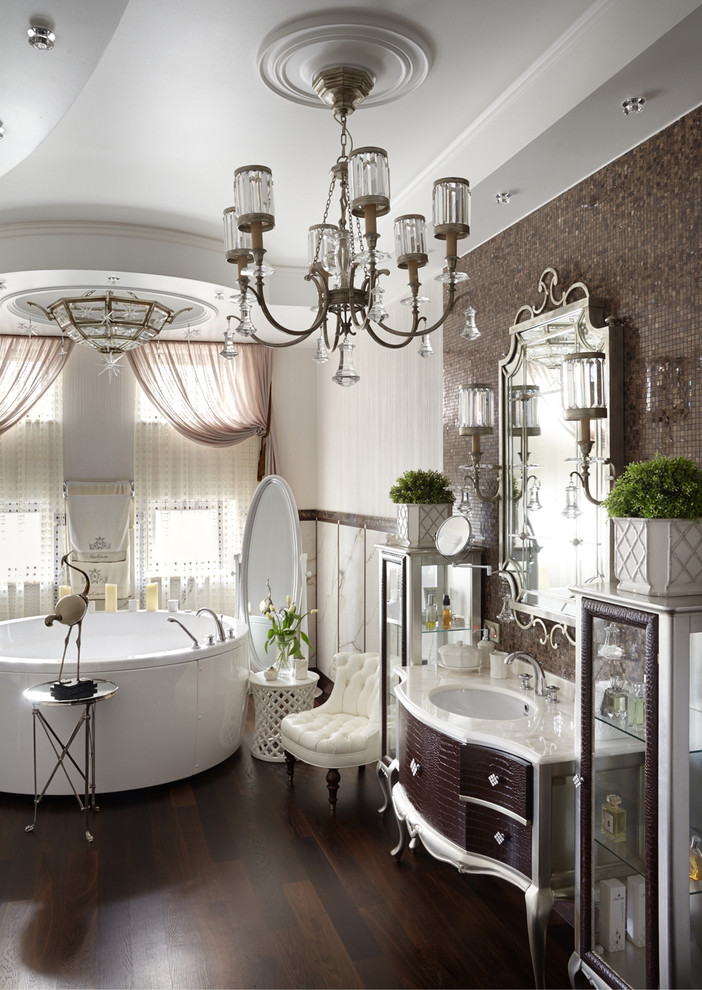 Источник вдохновения для домашнего уюта: главная ванная комната в стиле неоклассика (современная классика) с коричневыми фасадами, отдельно стоящей ванной, белой плиткой, коричневой плиткой, плиткой мозаикой, врезной раковиной и коричневым полом