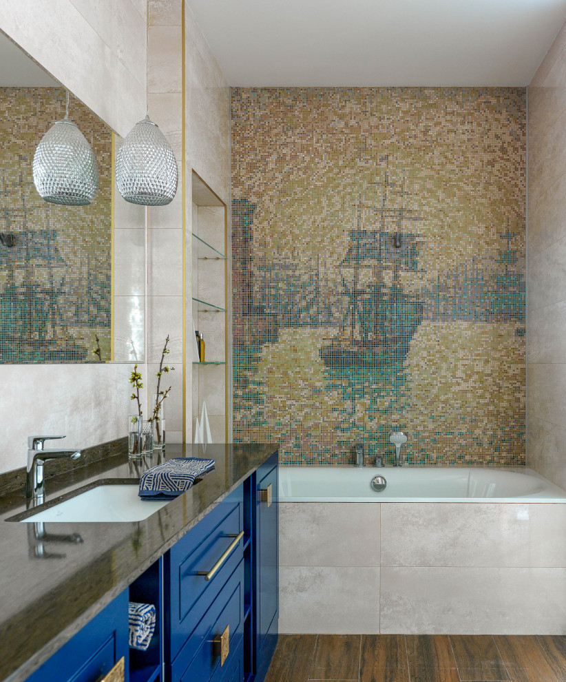 Идея дизайна: ванная комната в современном стиле с фасадами с выступающей филенкой, синими фасадами, накладной ванной, разноцветной плиткой, плиткой мозаикой, врезной раковиной, коричневым полом и коричневой столешницей