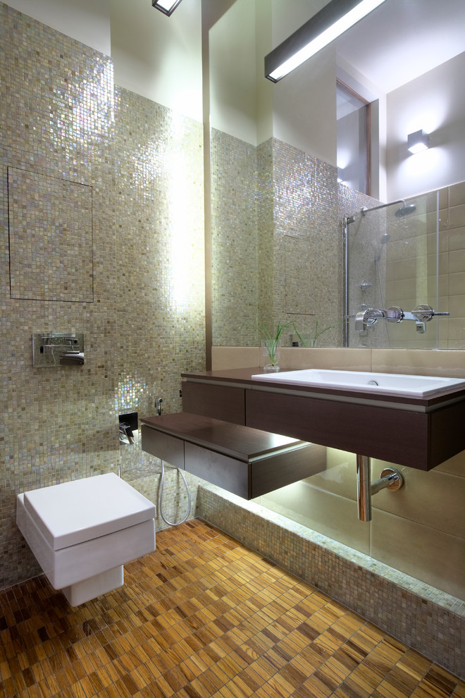 Photo of a contemporary shower room bathroom in Moscow with mosaic tiles, flat-panel cabinets, dark wood cabinets, a wall mounted toilet, a built-in sink, multi-coloured tiles and wooden worktops.