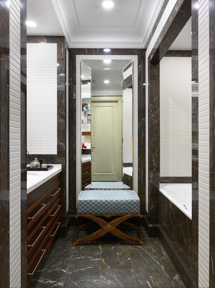 Inspiration for a medium sized traditional ensuite bathroom in Moscow with an alcove bath, brown tiles, white tiles, porcelain tiles, porcelain flooring, engineered stone worktops, brown floors, dark wood cabinets, a shower/bath combination, a submerged sink, white worktops and beaded cabinets.