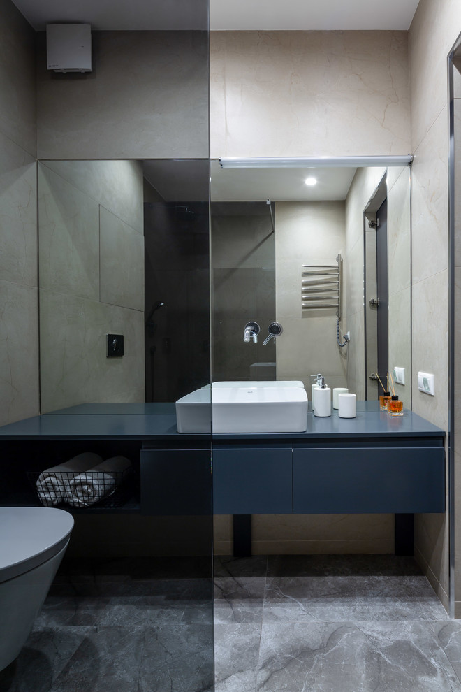 Design ideas for a small contemporary shower room bathroom in Other with flat-panel cabinets, blue cabinets, a walk-in shower, a wall mounted toilet, beige tiles, ceramic tiles, beige walls, ceramic flooring, a console sink, laminate worktops, beige floors, a shower curtain and blue worktops.