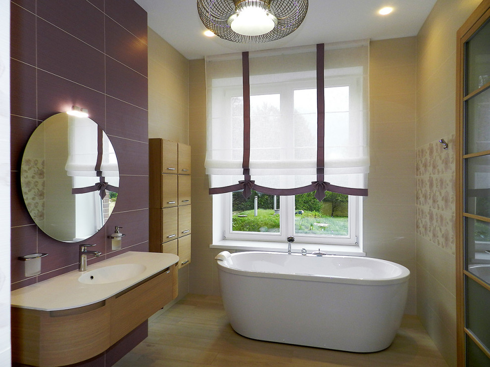 Large contemporary family bathroom in Moscow with flat-panel cabinets, light wood cabinets, a freestanding bath, beige tiles, ceramic tiles, purple walls, wood-effect flooring, a wall-mounted sink, solid surface worktops, beige floors, white worktops, a single sink and a floating vanity unit.