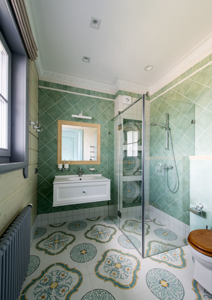 This is an example of a large mediterranean shower room bathroom with white cabinets, a walk-in shower, ceramic tiles, white walls, porcelain flooring, multi-coloured floors, recessed-panel cabinets, green tiles, a hinged door and white worktops.