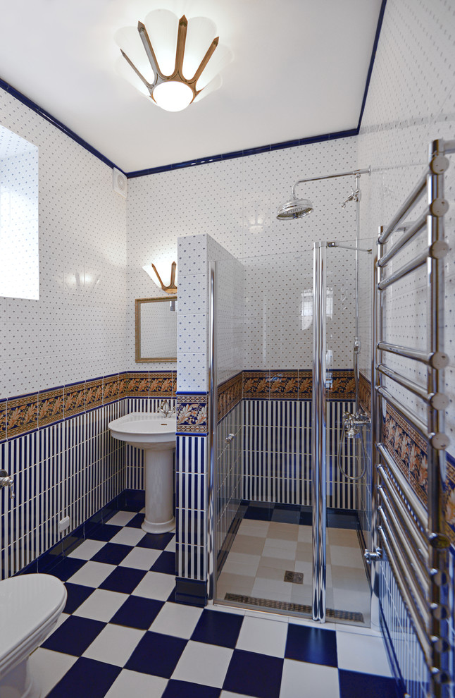 Inspiration for a small classic shower room bathroom in Other with an alcove shower, a wall mounted toilet, blue tiles, ceramic tiles, blue walls, ceramic flooring, a pedestal sink, tiled worktops, blue floors and a hinged door.