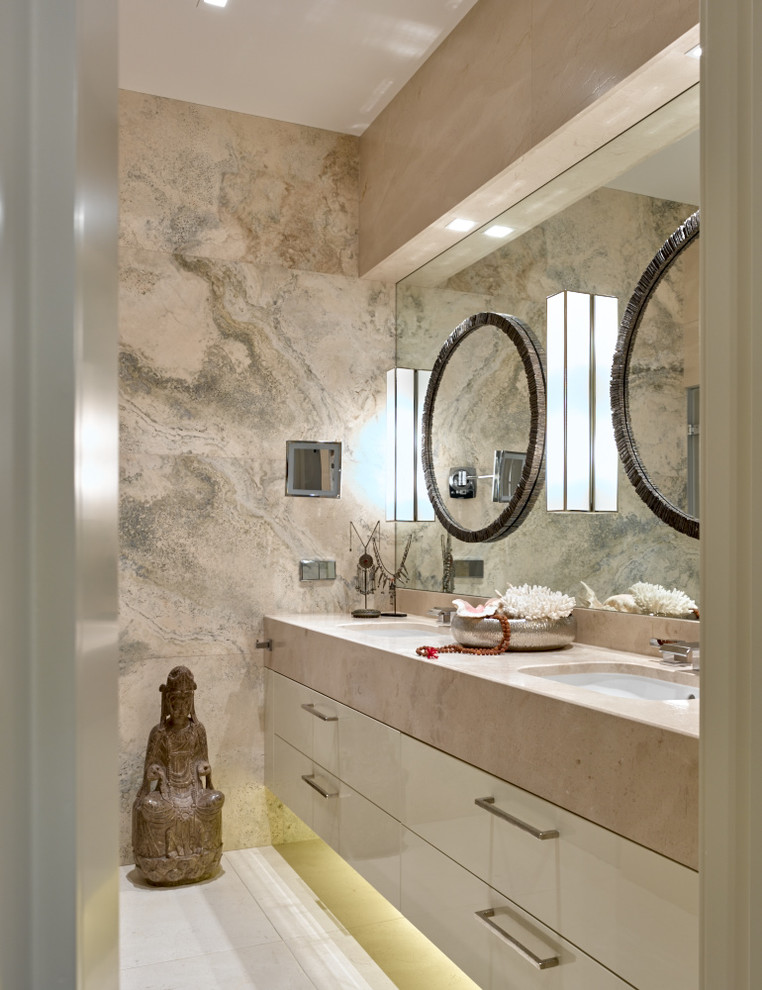 На фото: ванная комната в современном стиле с бежевой плиткой и врезной раковиной с