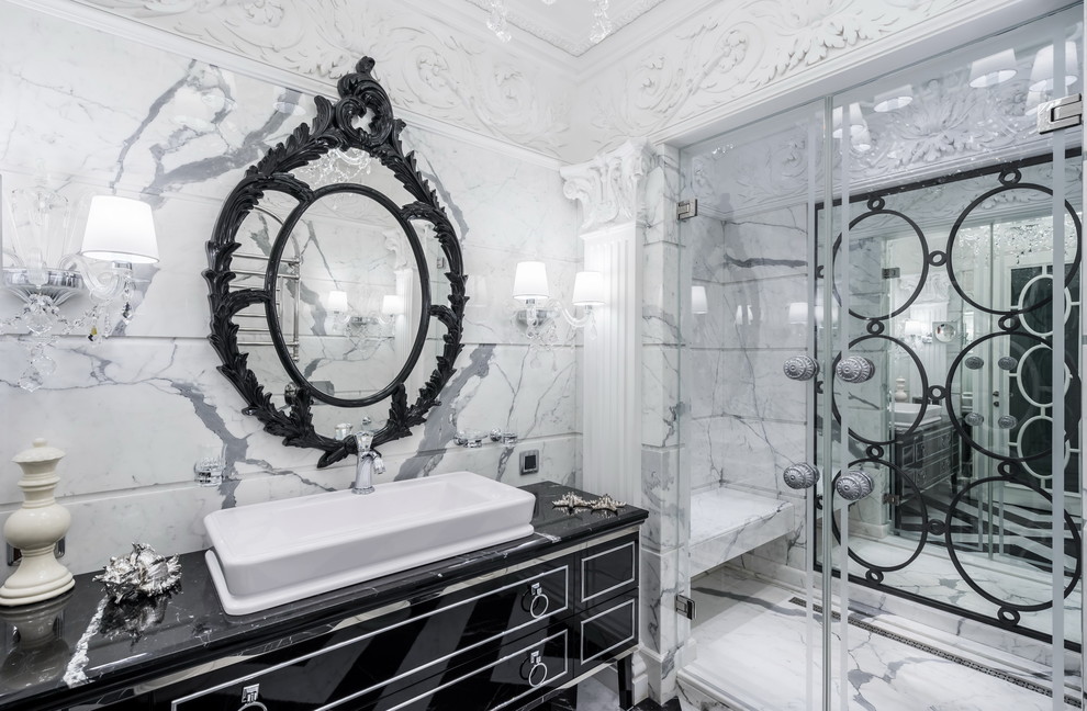 This is an example of a traditional shower room bathroom in Saint Petersburg with black cabinets, an alcove shower, white tiles, grey tiles, marble tiles, a vessel sink, marble worktops, a hinged door, white walls and flat-panel cabinets.
