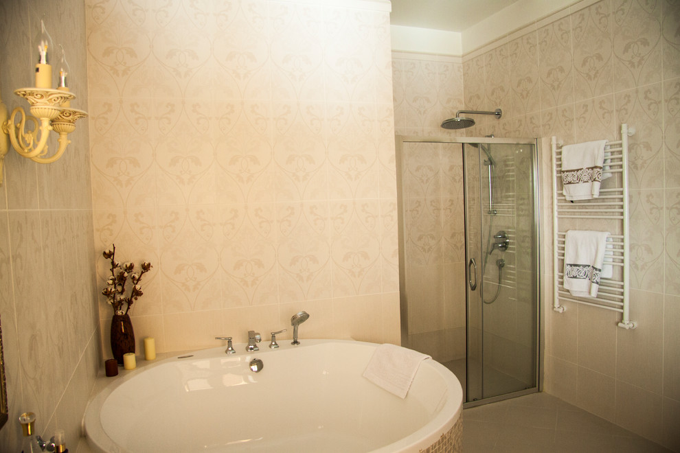 Photo of a large traditional ensuite bathroom in Moscow with raised-panel cabinets, beige cabinets, a submerged bath, beige tiles, ceramic tiles, beige walls, porcelain flooring, an integrated sink, solid surface worktops, beige floors and beige worktops.