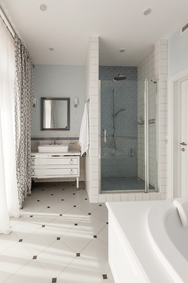 Inspiration for a traditional ensuite bathroom in Moscow with white cabinets, a built-in bath, an alcove shower, white tiles, blue walls, a vessel sink, white floors and a hinged door.