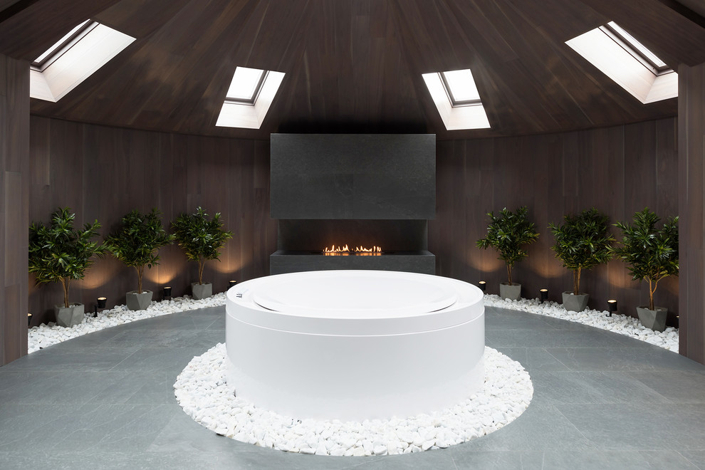 Modelo de cuarto de baño contemporáneo con bañera exenta y suelo gris