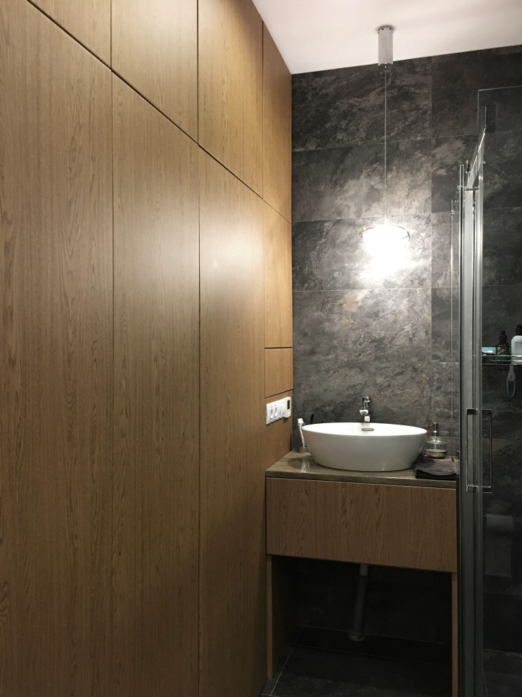 Exempel på ett mellanstort modernt grå grått badrum med dusch, med släta luckor, skåp i mellenmörkt trä, grå kakel, porslinskakel, grå väggar, klinkergolv i porslin, ett fristående handfat, bänkskiva i akrylsten och grått golv