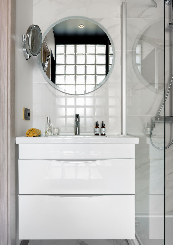 This is an example of a small eclectic shower room bathroom in Moscow with flat-panel cabinets, white cabinets, a corner shower, a wall mounted toilet, white tiles, porcelain tiles, white walls, porcelain flooring, a built-in sink, white floors, a shower curtain, white worktops, a laundry area, a single sink and a floating vanity unit.