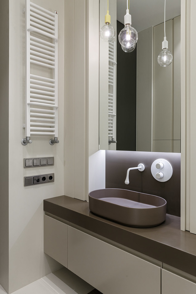 Photo of a contemporary ensuite bathroom in Saint Petersburg with flat-panel cabinets, beige tiles, brown worktops, beige cabinets, beige walls, a vessel sink and beige floors.