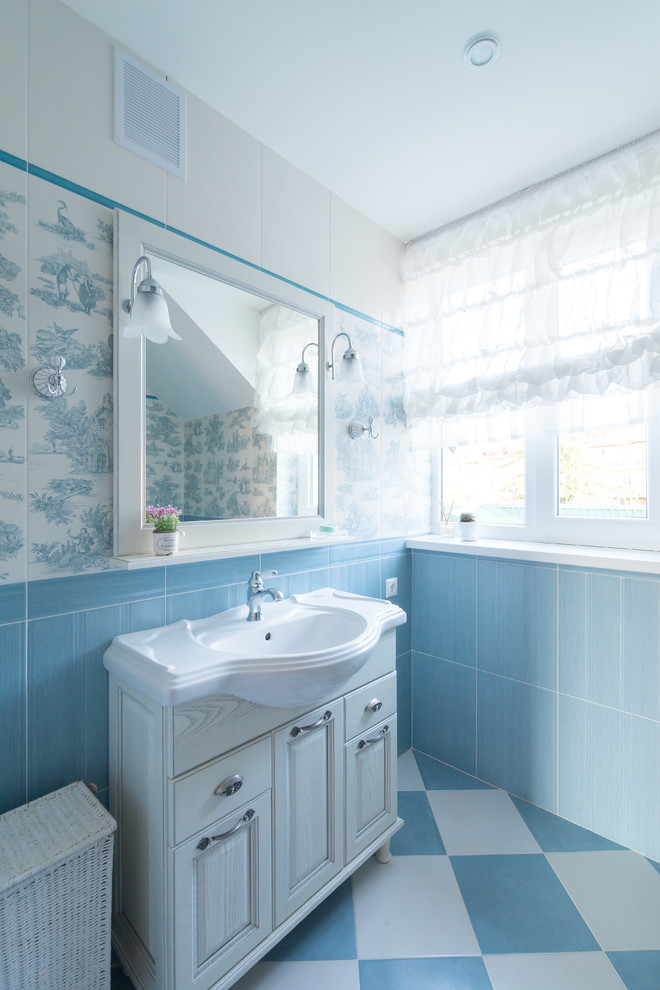 Inspiration for a mid-sized country kids' multicolored tile and mosaic tile ceramic tile and multicolored floor alcove shower remodel in Other with recessed-panel cabinets, white cabinets, a wall-mount toilet, multicolored walls, a drop-in sink and a hinged shower door