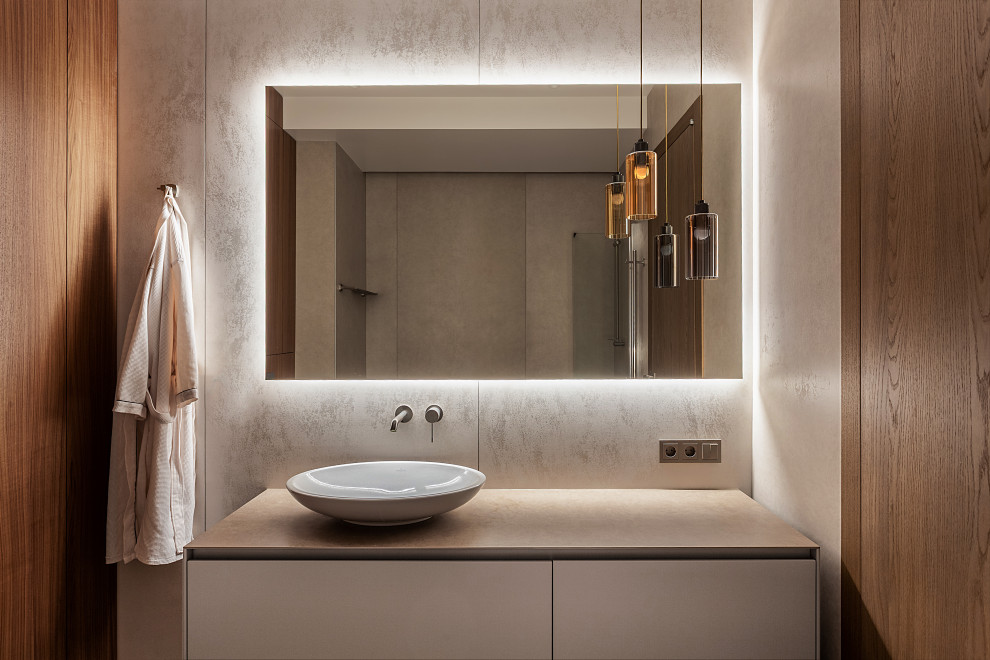 Cette photo montre une salle de bain tendance en bois avec un placard à porte plane, des portes de placard grises, un carrelage gris, une vasque, un plan de toilette gris et meuble simple vasque.