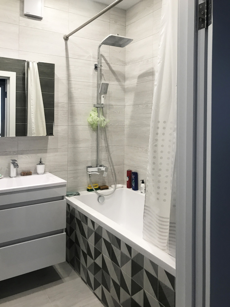 Пример оригинального дизайна: ванная комната в современном стиле с плоскими фасадами, белыми фасадами, ванной в нише, душем над ванной, серой плиткой, консольной раковиной, серым полом, шторкой для ванной, тумбой под одну раковину и подвесной тумбой