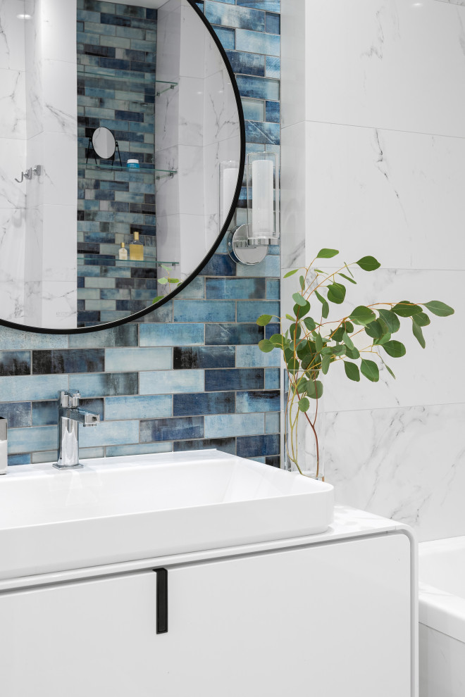 Example of a mid-sized trendy master white tile and porcelain tile porcelain tile, white floor and single-sink bathroom design in Saint Petersburg with white cabinets, a wall-mount toilet, white walls, a console sink, solid surface countertops, white countertops and a floating vanity