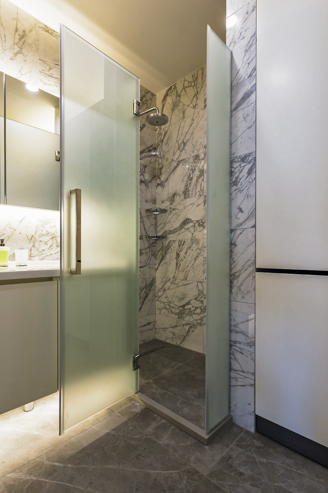 Aménagement d'une salle de bain contemporaine avec un placard à porte plane, un lavabo encastré et un sol gris.