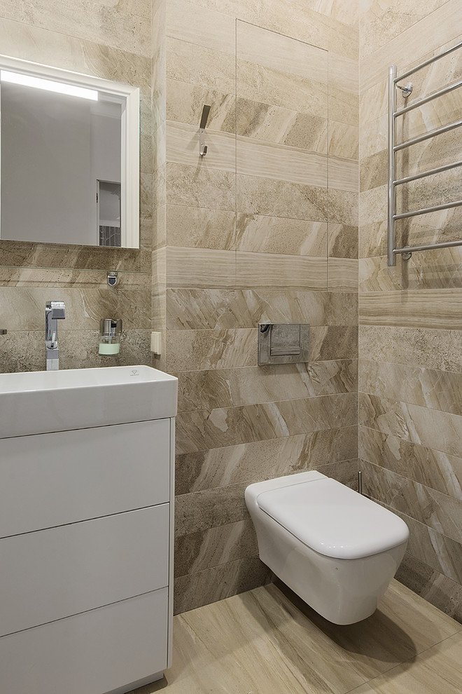 Стильный дизайн: ванная комната среднего размера в современном стиле с инсталляцией, бежевой плиткой, керамогранитной плиткой, полом из керамогранита, бежевым полом и монолитной раковиной - последний тренд