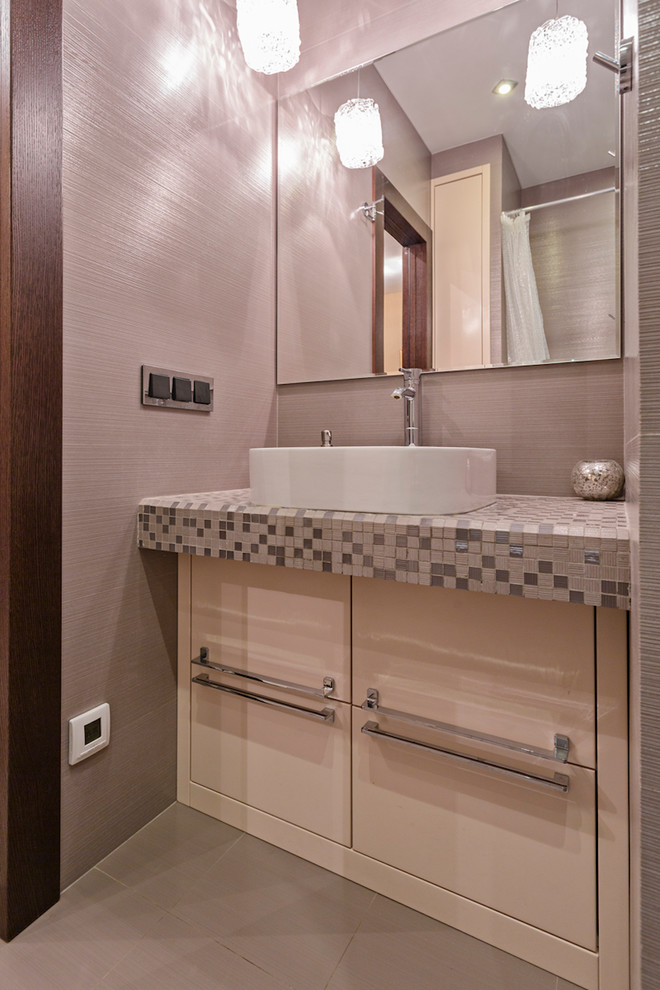 Photo of a contemporary bathroom in Moscow with an alcove bath, a shower/bath combination, a wall mounted toilet, pink tiles and a shower curtain.