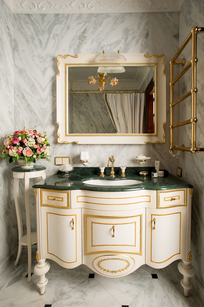 Inspiration pour une salle de bain traditionnelle avec des portes de placard beiges, un carrelage gris, un sol en marbre et un lavabo encastré.