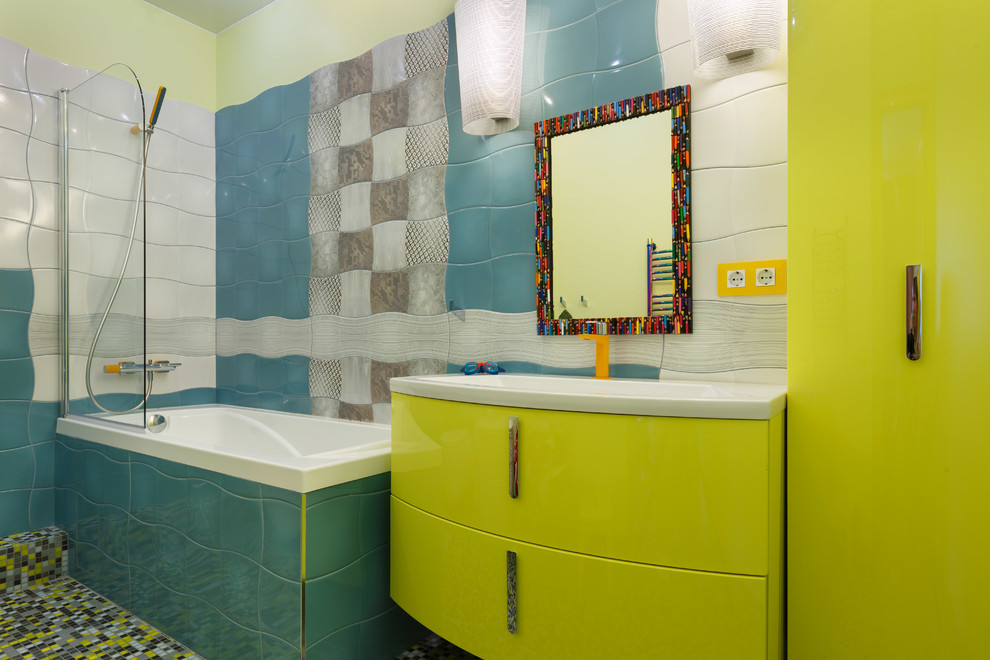This is an example of a contemporary family bathroom in Saint Petersburg with ceramic tiles, mosaic tile flooring, a built-in sink, flat-panel cabinets, green cabinets, a built-in bath, a shower/bath combination, blue tiles, white tiles, multi-coloured tiles and multi-coloured walls.