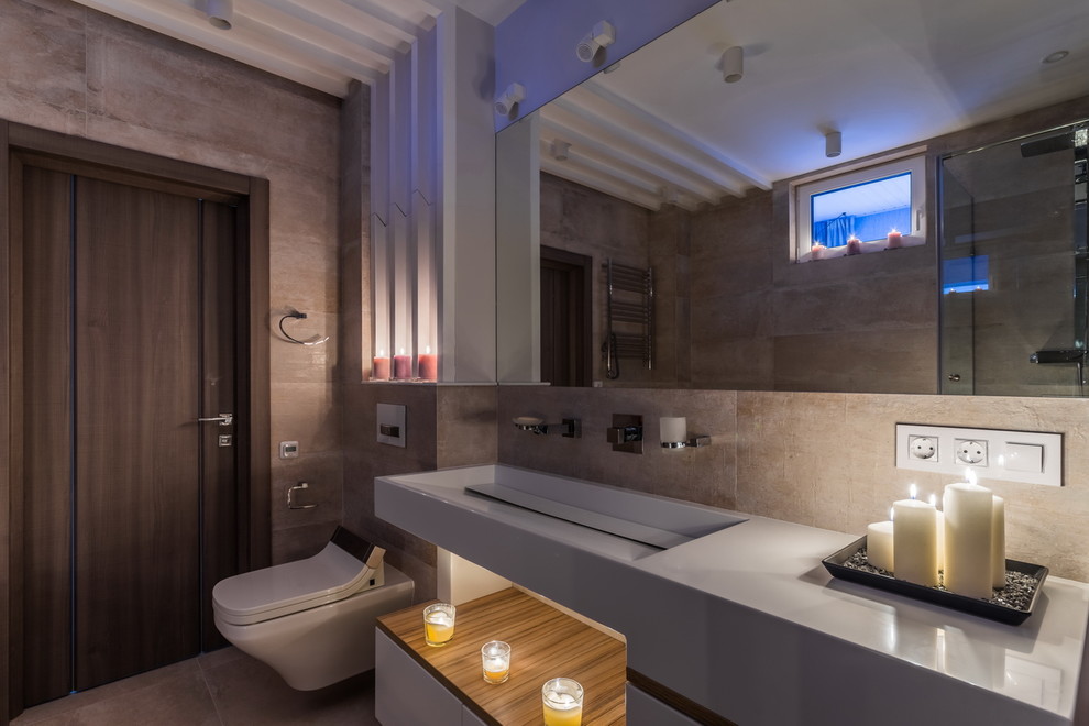 Cette image montre une salle de bain design avec WC suspendus et un lavabo intégré.