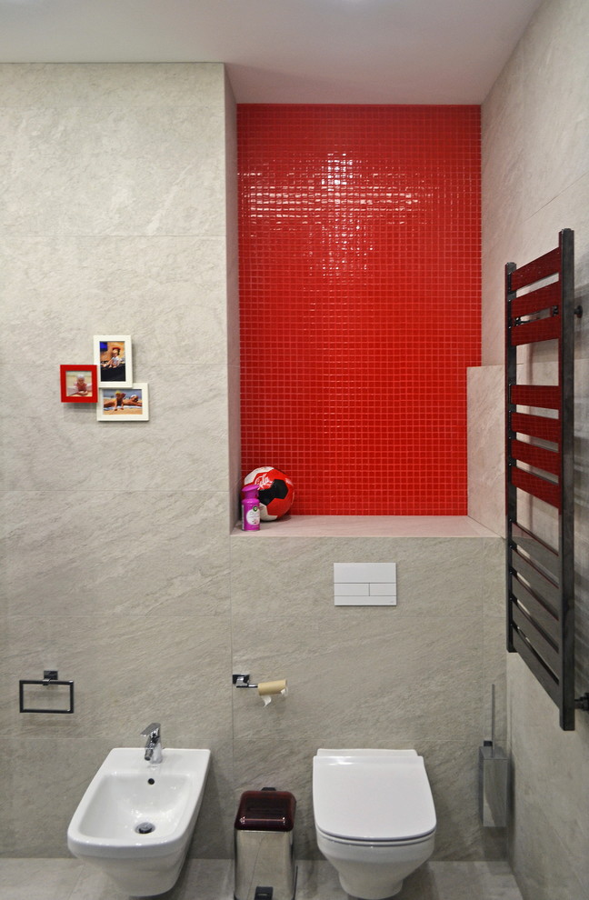 This is an example of a medium sized contemporary ensuite bathroom in Moscow with flat-panel cabinets, white cabinets, a submerged bath, a bidet, red tiles, porcelain tiles, white walls, porcelain flooring, an integrated sink, solid surface worktops, grey floors, white worktops, an enclosed toilet, double sinks and a floating vanity unit.