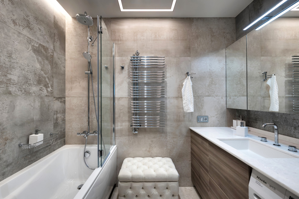Medium sized contemporary ensuite bathroom in Saint Petersburg with flat-panel cabinets, medium wood cabinets, an alcove bath, a shower/bath combination, beige tiles, porcelain tiles, porcelain flooring, a submerged sink, solid surface worktops, a hinged door and white worktops.