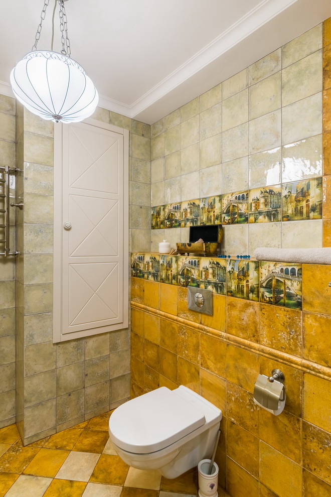 Foto de cuarto de baño romántico con sanitario de pared, baldosas y/o azulejos amarillos y suelo amarillo