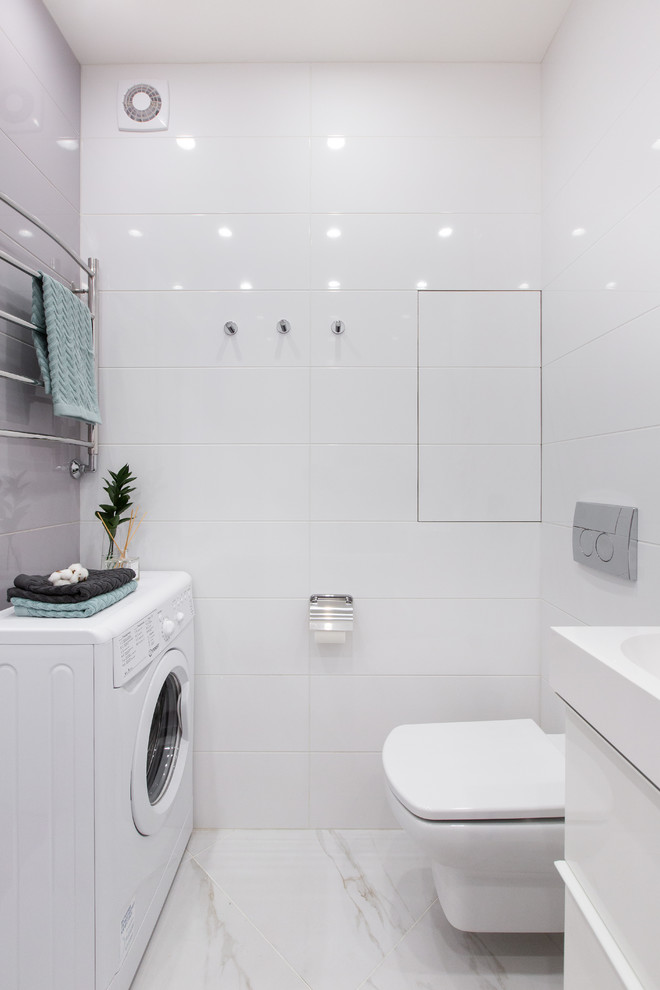 Inspiration for a small ensuite bathroom in Moscow with flat-panel cabinets, white cabinets, a submerged bath, a wall mounted toilet, grey tiles, ceramic tiles, white walls, porcelain flooring, a wall-mounted sink, solid surface worktops, grey floors and white worktops.