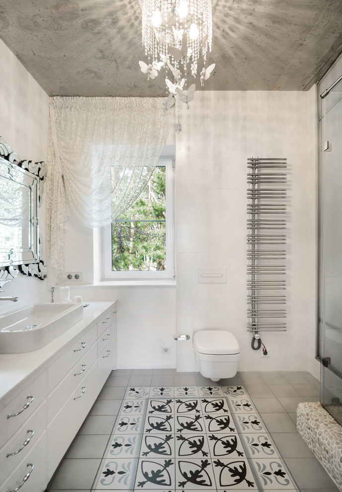 Photo of a medium sized contemporary shower room bathroom in Novosibirsk with white cabinets, an alcove shower, a wall mounted toilet, ceramic flooring, solid surface worktops, grey floors, a hinged door and white worktops.