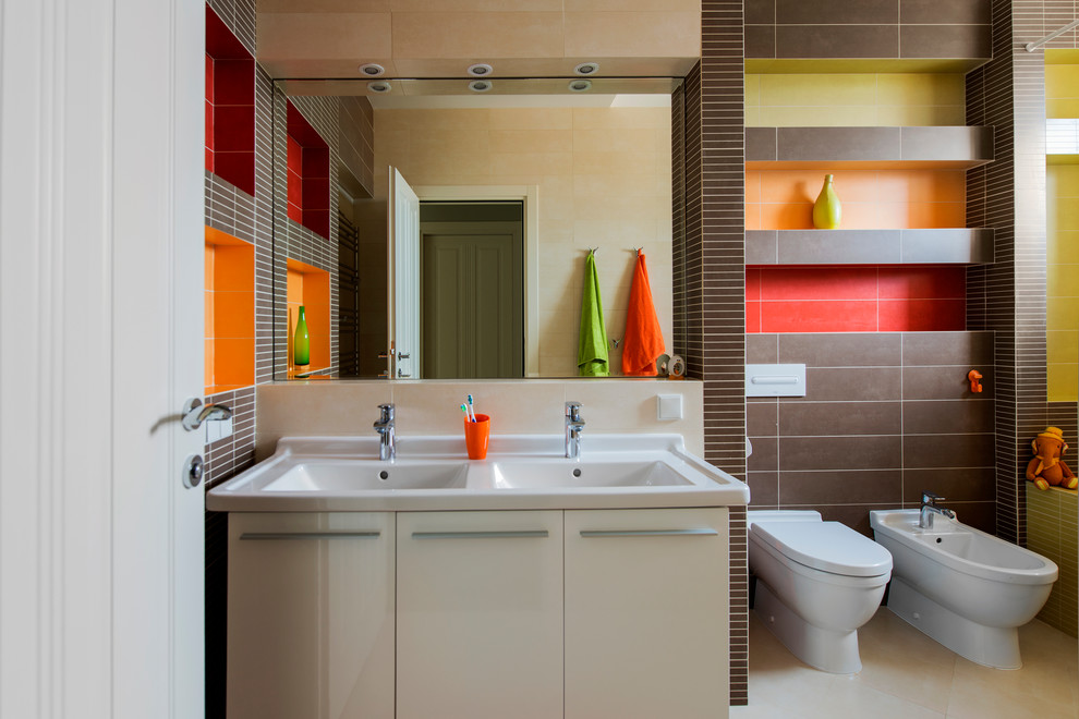 This is an example of a contemporary family bathroom in Moscow with flat-panel cabinets, white cabinets, a bidet, brown tiles, multi-coloured tiles and a trough sink.