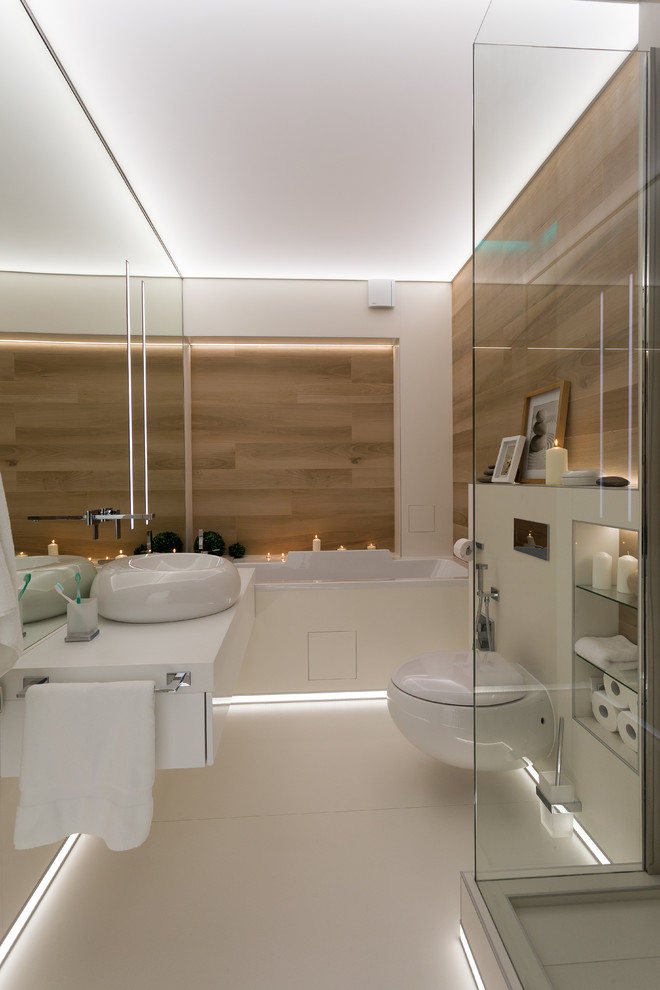 Imagen de cuarto de baño principal y blanco y madera contemporáneo con armarios con paneles lisos, puertas de armario blancas, bañera empotrada, ducha esquinera, sanitario de pared, lavabo sobreencimera, suelo blanco y encimeras blancas
