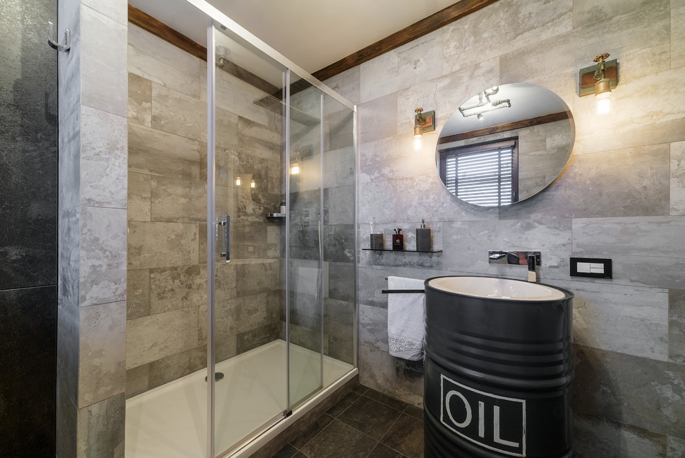 Mid-sized urban 3/4 gray tile and porcelain tile porcelain tile and gray floor bathroom photo in Other with flat-panel cabinets, black cabinets, a wall-mount toilet, gray walls and a drop-in sink