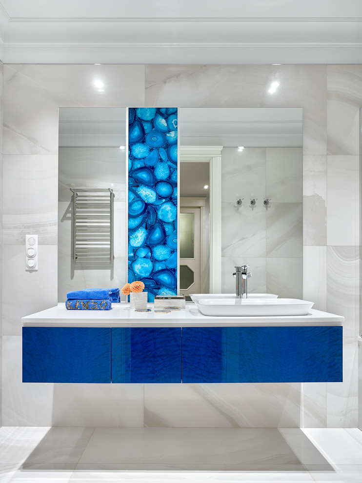 Photo of a contemporary bathroom in Moscow with flat-panel cabinets, blue cabinets, grey tiles, a vessel sink, grey floors, grey walls, porcelain tiles and porcelain flooring.