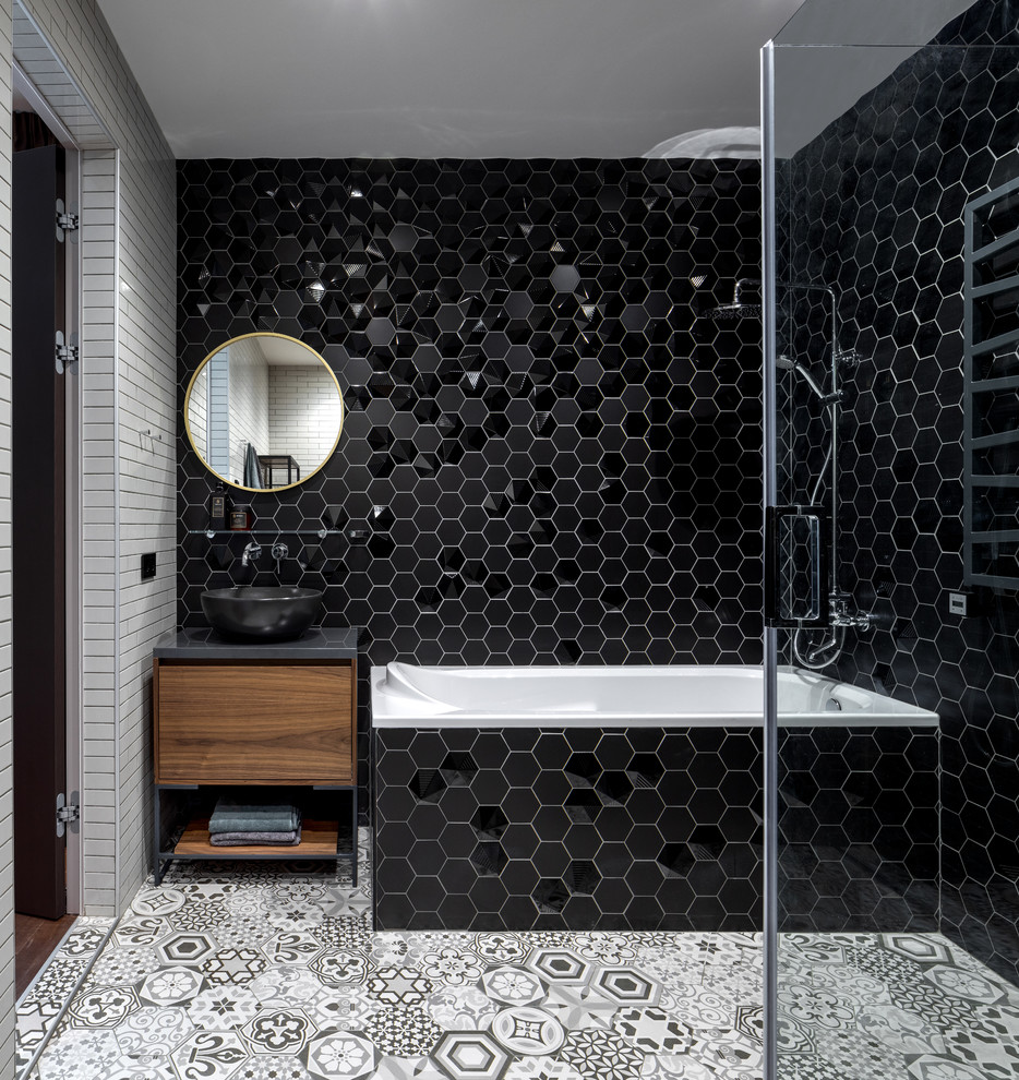 Corner bathtub - large contemporary master ceramic tile and black tile ceramic tile and gray floor corner bathtub idea in Moscow with flat-panel cabinets, solid surface countertops, gray countertops, a vessel sink and medium tone wood cabinets