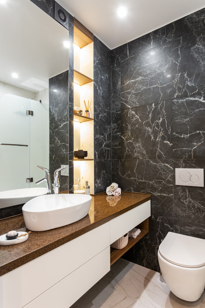 Medium sized contemporary ensuite bathroom in Moscow with flat-panel cabinets, white cabinets, a wall mounted toilet, black and white tiles, porcelain tiles, porcelain flooring, a vessel sink, grey floors and brown worktops.