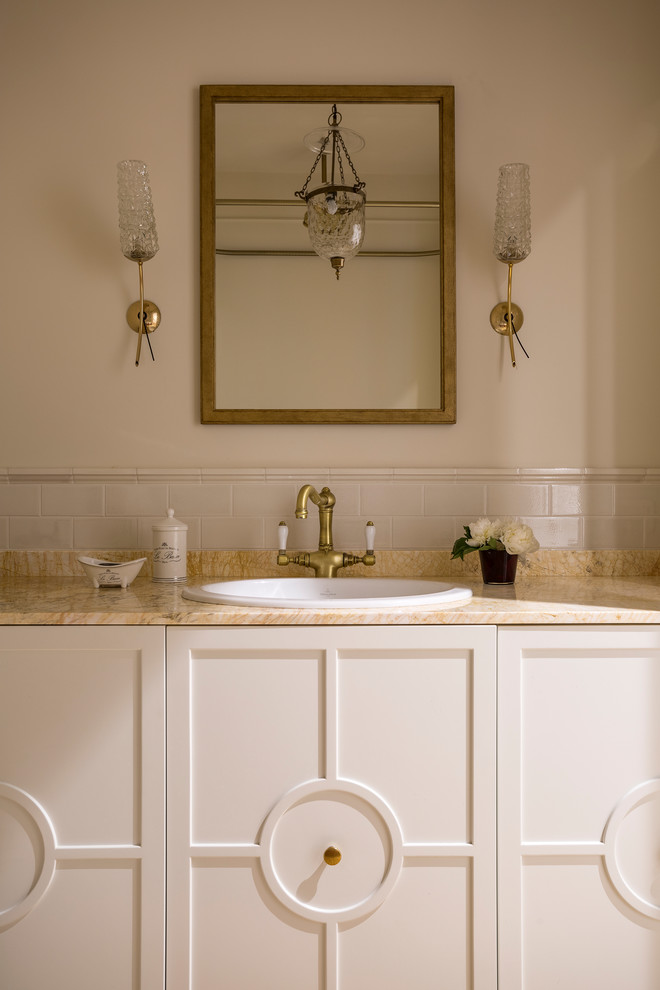 Bohemian bathroom in Moscow with recessed-panel cabinets, white cabinets, beige tiles, beige walls, a built-in sink and beige worktops.