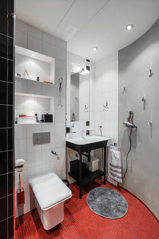 Modelo de cuarto de baño contemporáneo con sanitario de pared, baldosas y/o azulejos blancas y negros, baldosas y/o azulejos rojos, baldosas y/o azulejos de cerámica, paredes grises, suelo con mosaicos de baldosas, aseo y ducha y lavabo tipo consola